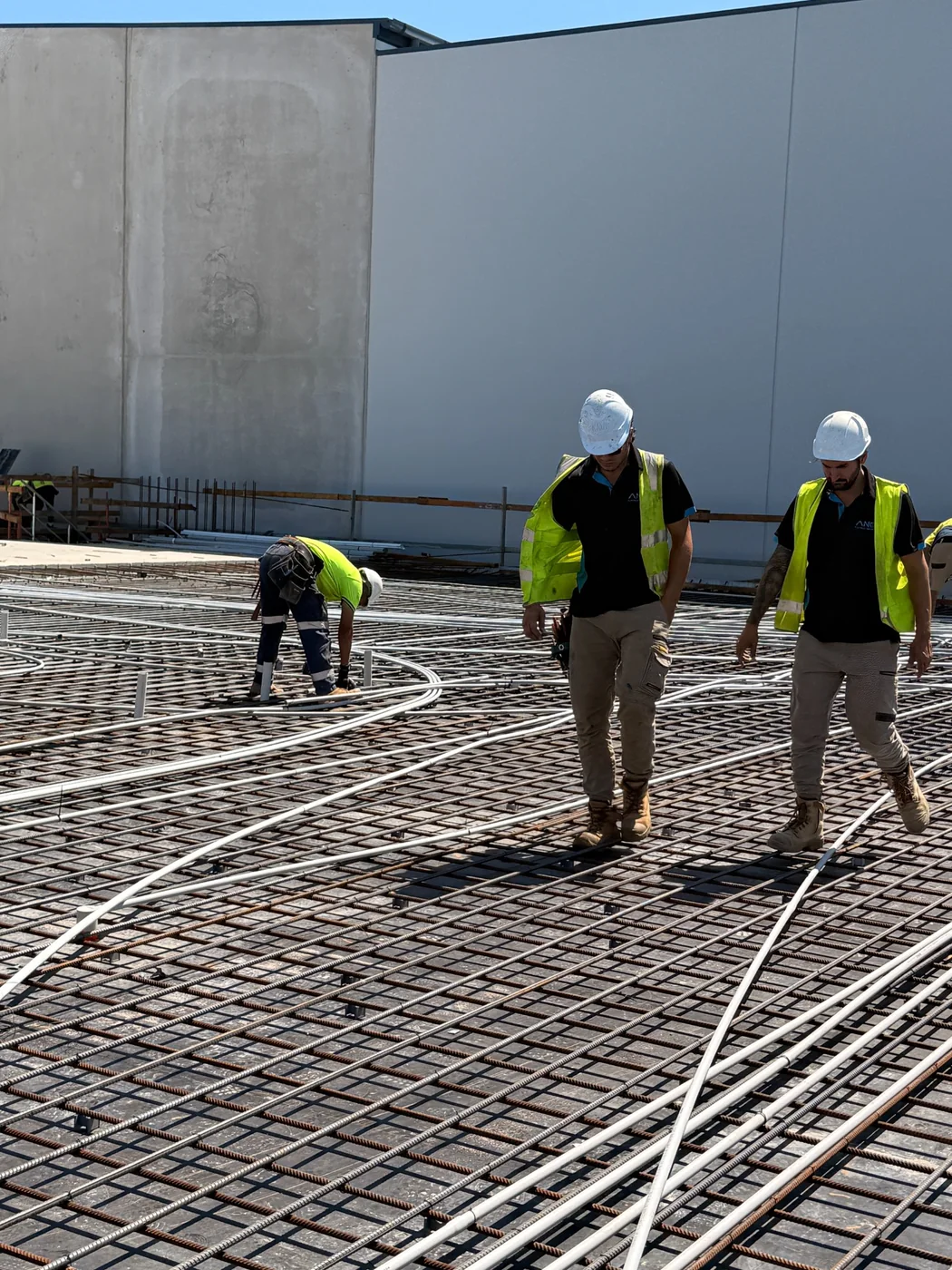 Construction workers on an active slab with security infrastructure